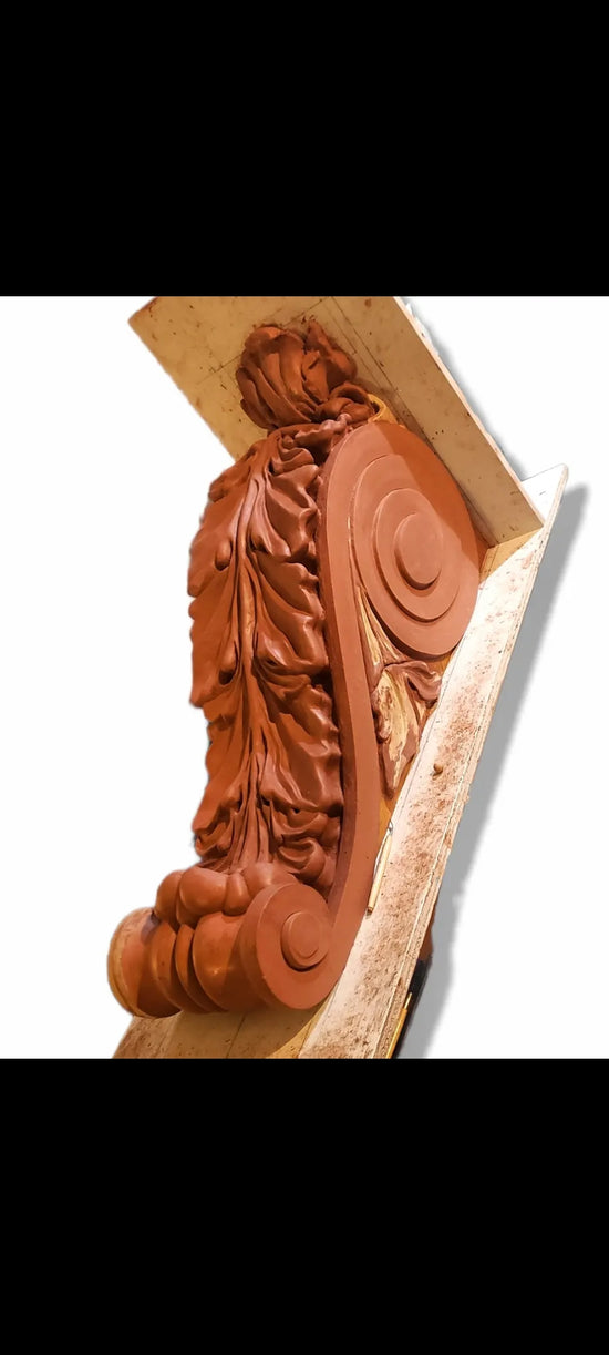 Hand sculpted rendering from a phone image screen shot of these corbels in the background of a photo of a computer screen showing a still from a black and white film. a